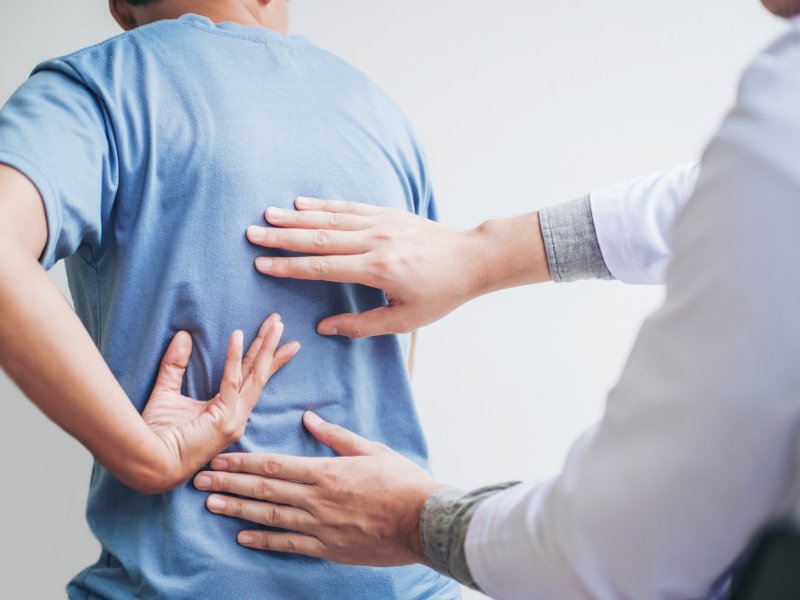 doctor examining patient's back