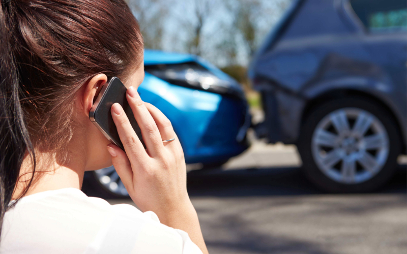 Female Driver Making Phone Call After Traffic Accident