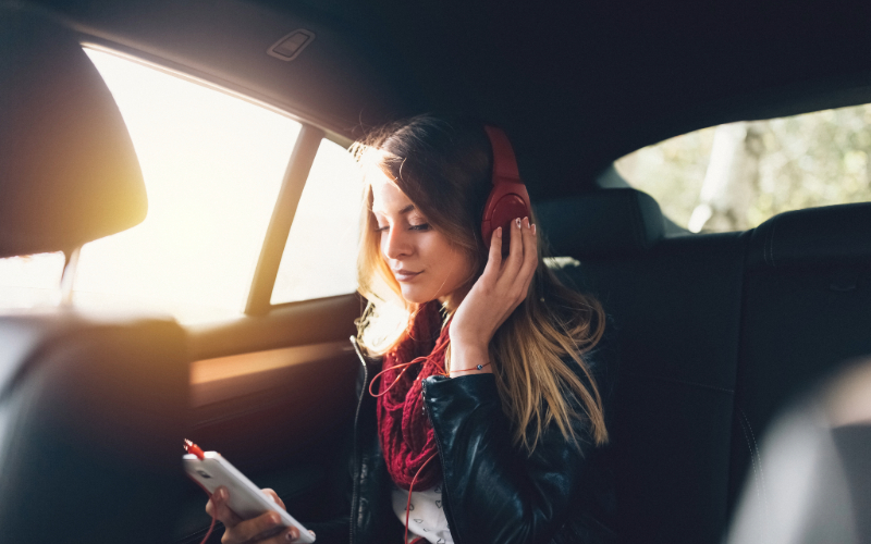 Woman on a road trip listening to the music